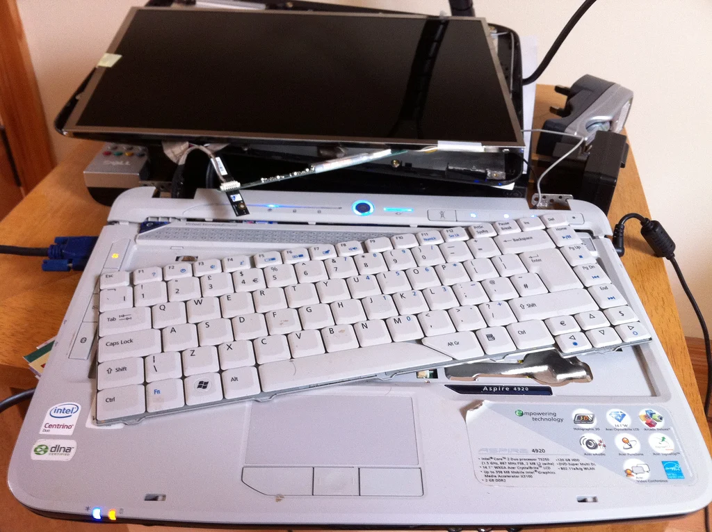 Two computers illustrating the choice between repairing or replacing a computer